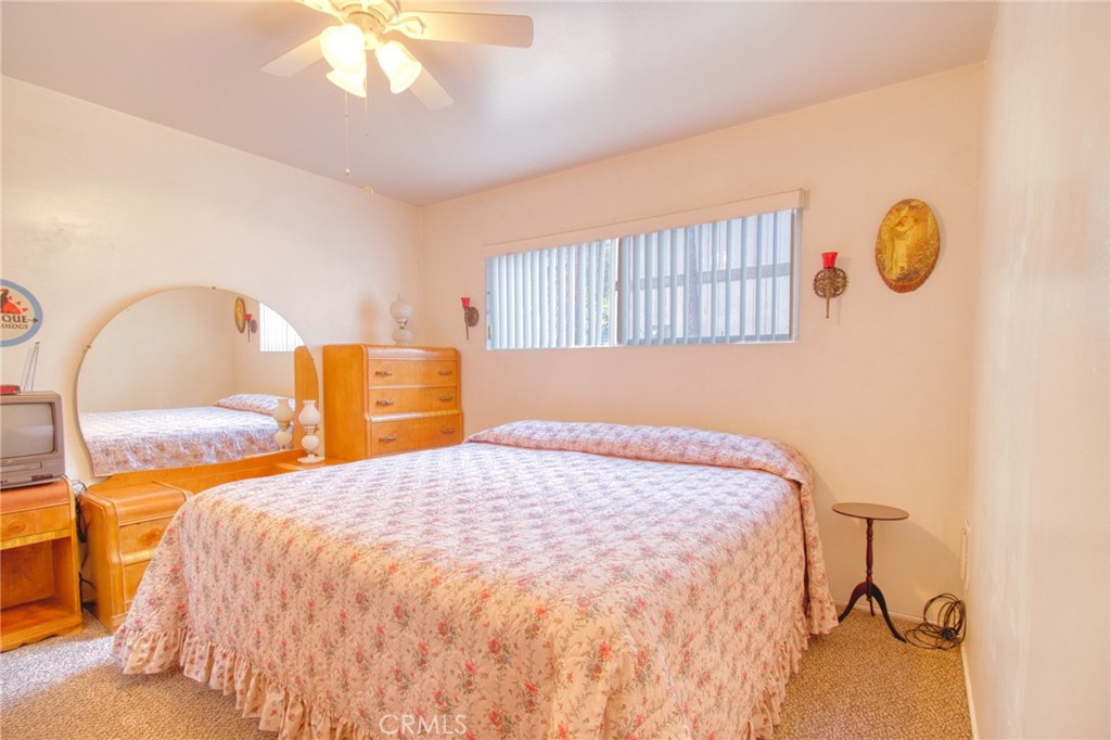 1215 Lark Road Wrightwood, CA 92397 - Photo 12 of 34 a bedroom with a bed and a chandelier