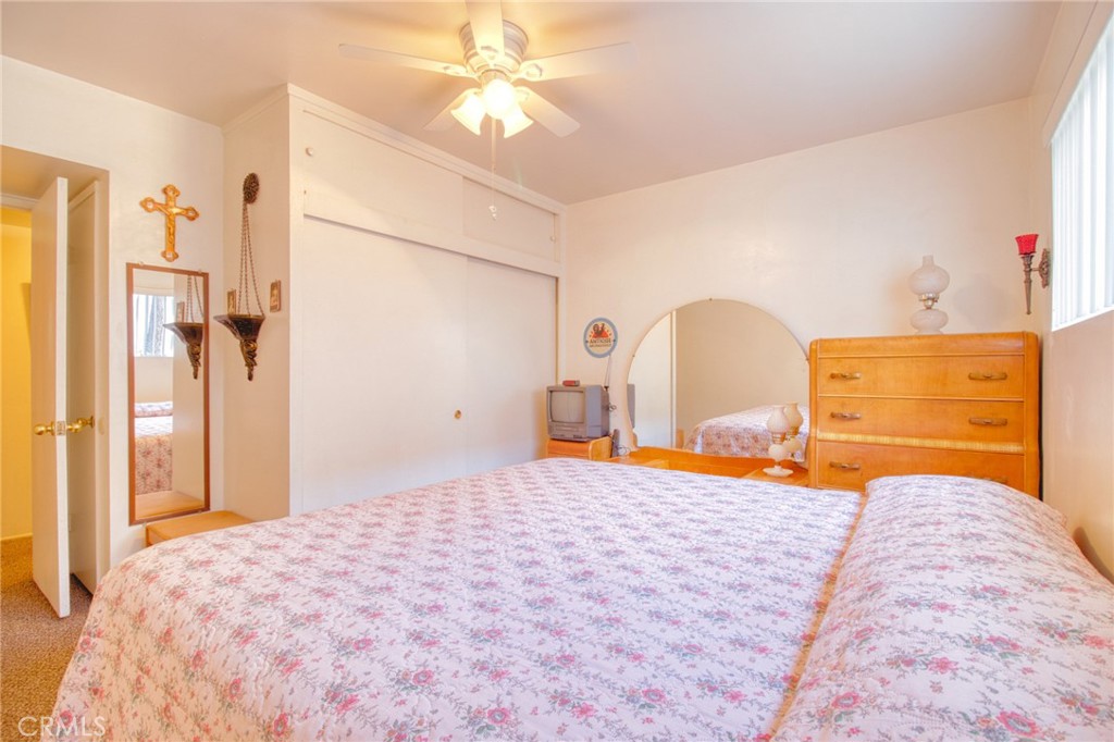 1215 Lark Road Wrightwood, CA 92397 - Photo 13 of 34 a bedroom with a bed and a chandelier