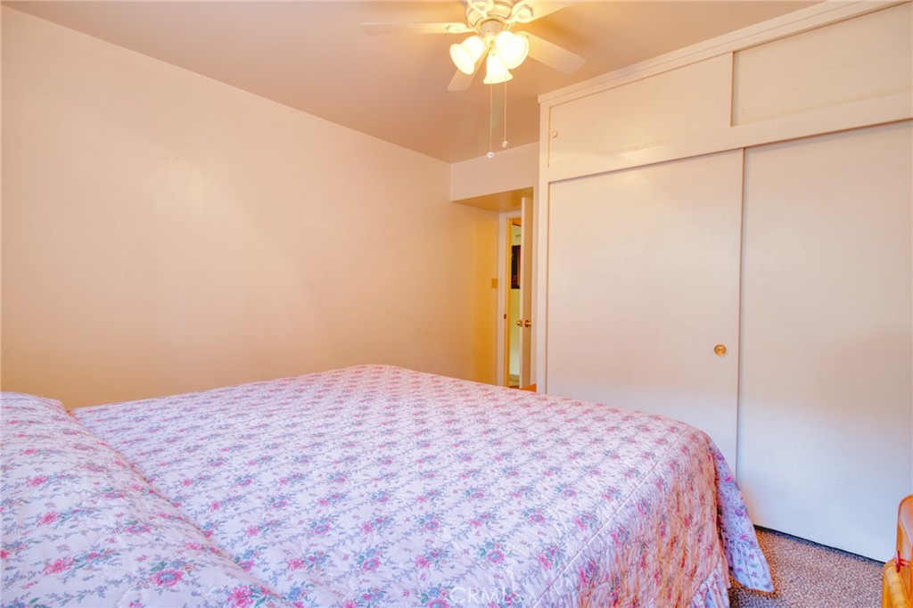 1215 Lark Road Wrightwood, CA 92397 - Photo 14 of 34 a bedroom with a bed and a chandelier