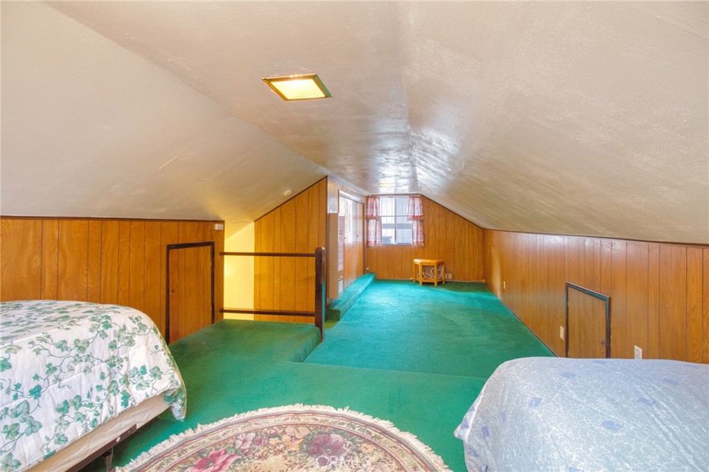 1215 Lark Road Wrightwood, CA 92397 - Photo 21 of 34 a bedroom with bed and a chandelier