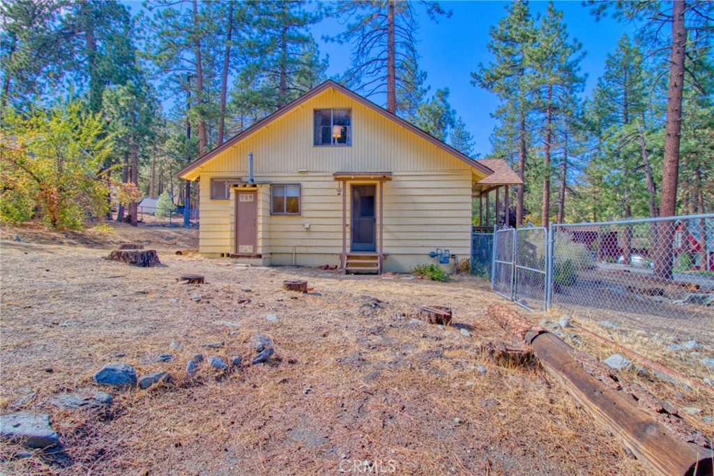 1215 Lark Road Wrightwood, CA 92397 - Photo 24 of 34 a view of a small house with a yard