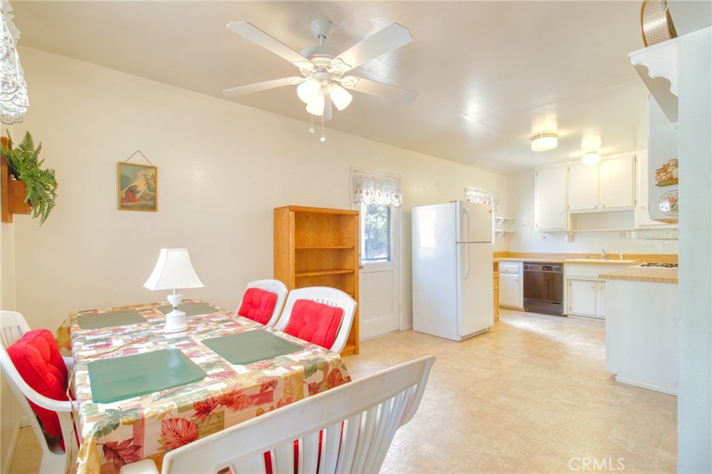 1215 Lark Road Wrightwood, CA 92397 - Photo 7 of 34 a view of a kitchen and a dining table & chairs