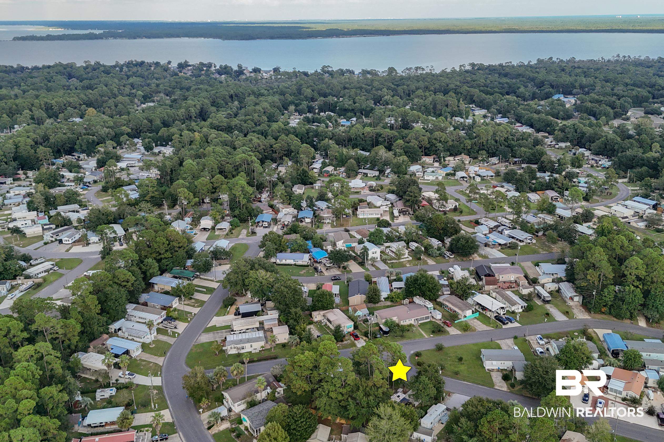 271 Defuniak Circle Lillian, AL 36549 - Photo 17 of 20 Aerial overview of property's location with nearby suburban area