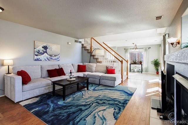 20000 Mitchell Place, Unit 53 Denver, CO 80249 - Photo 2 of 40 a living room with furniture and a fireplace