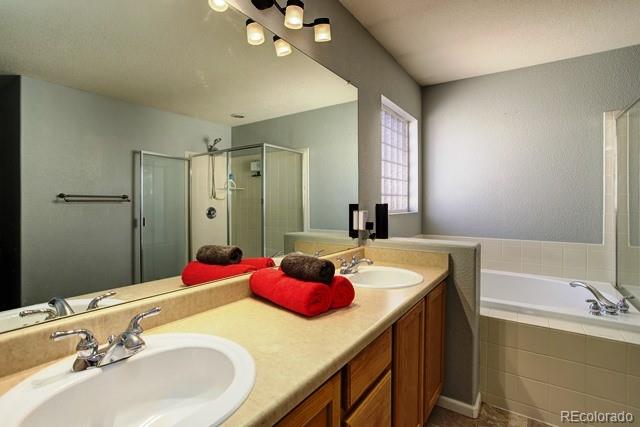 20000 Mitchell Place, Unit 53 Denver, CO 80249 - Photo 21 of 40 a bathroom with a tub sink and mirror