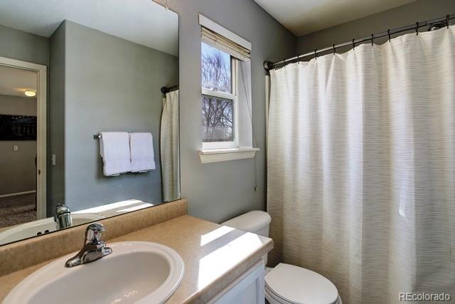 20000 Mitchell Place, Unit 53 Denver, CO 80249 - Photo 24 of 40 a bathroom with a sink toilet and mirror