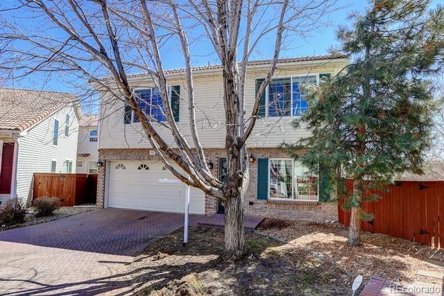20000 Mitchell Place, Unit 53 Denver, CO 80249 - Photo 32 of 40 a tree in front of a white house
