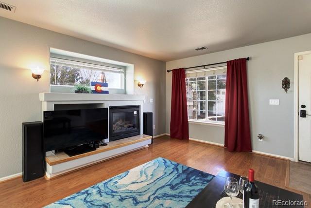 20000 Mitchell Place, Unit 53 Denver, CO 80249 - Photo 5 of 40 a living room with furniture and a fireplace