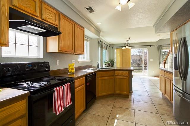 20000 Mitchell Place, Unit 53 Denver, CO 80249 - Photo 10 of 40 a kitchen with a sink a stove cabinets and a dining table