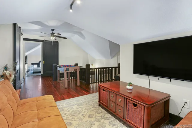 a living room with furniture and a flat screen tv