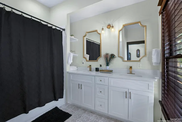 a bathroom with a double vanity sink and mirror