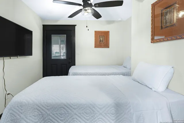 a bedroom with a bed and a flat screen tv