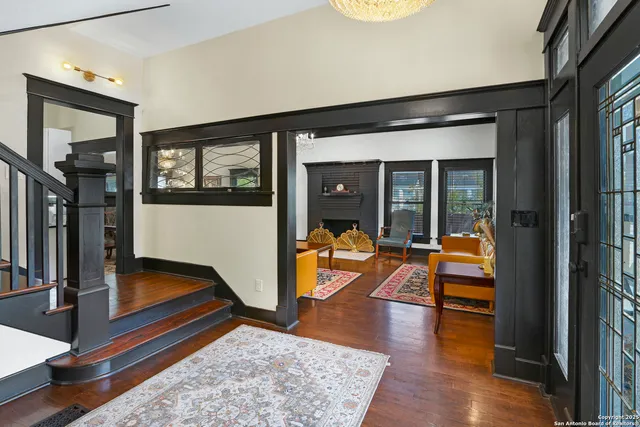 a hallway with wooden floor and a large window