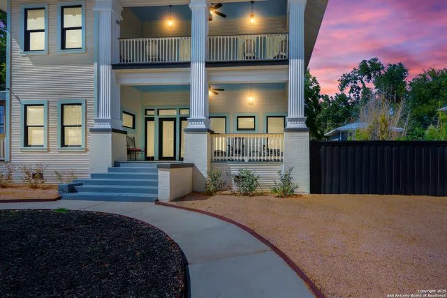 a view of a house with backyard and sitting area