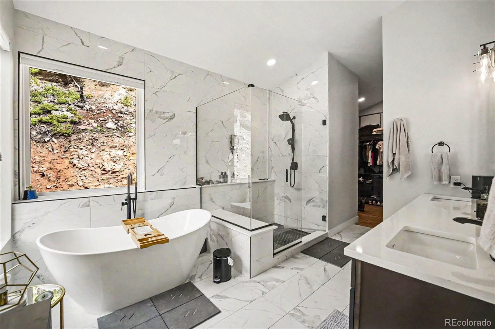 7231 Timber Trail Road Evergreen, CO 80439 - Photo 18 of 35 a bathroom with a bathtub and a sink