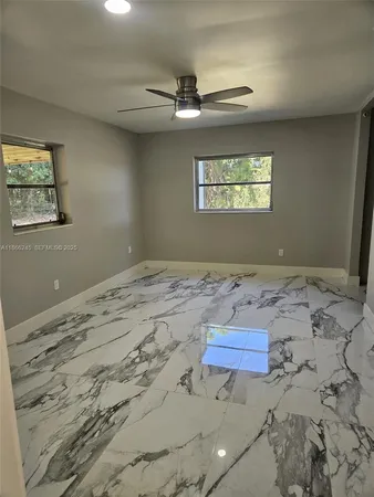 a room with a table chairs and a refrigerator