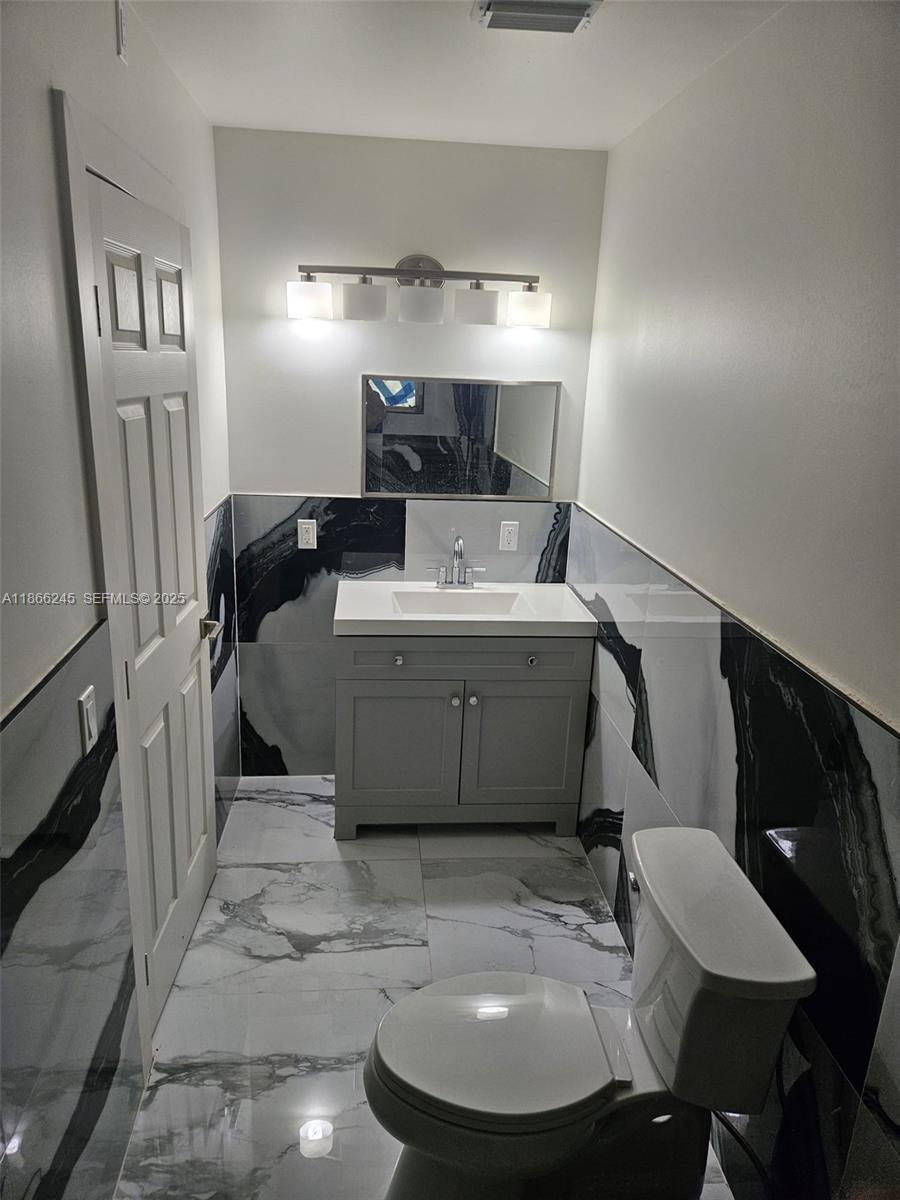 19230 Southwest 216th Street Miami, FL 33170 - Photo 12 of 55 a room with a table chairs and a refrigerator