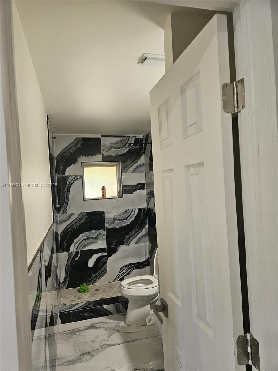 19230 Southwest 216th Street Miami, FL 33170 - Photo 14 of 55 a view of walk in closet with clothes and shoes