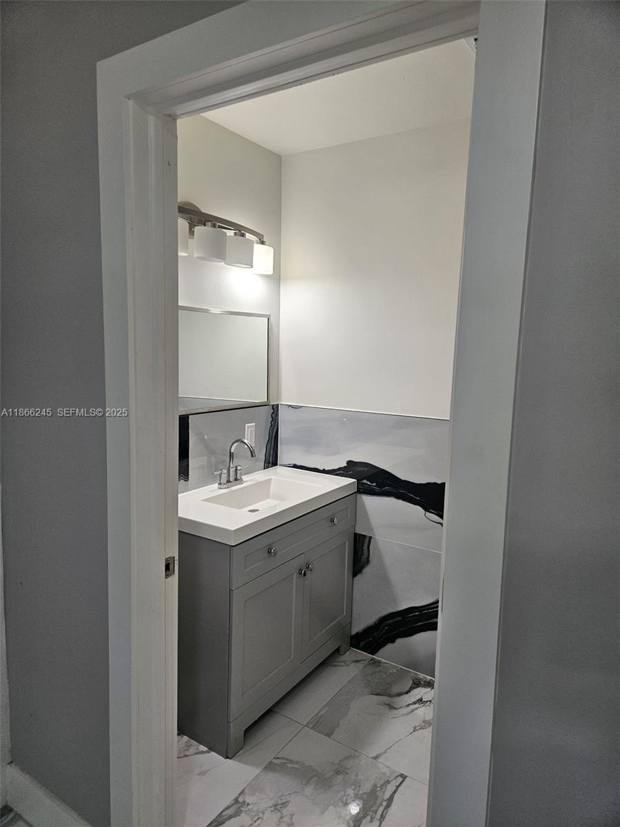19230 Southwest 216th Street Miami, FL 33170 - Photo 15 of 55 a bathroom with a sink and a mirror