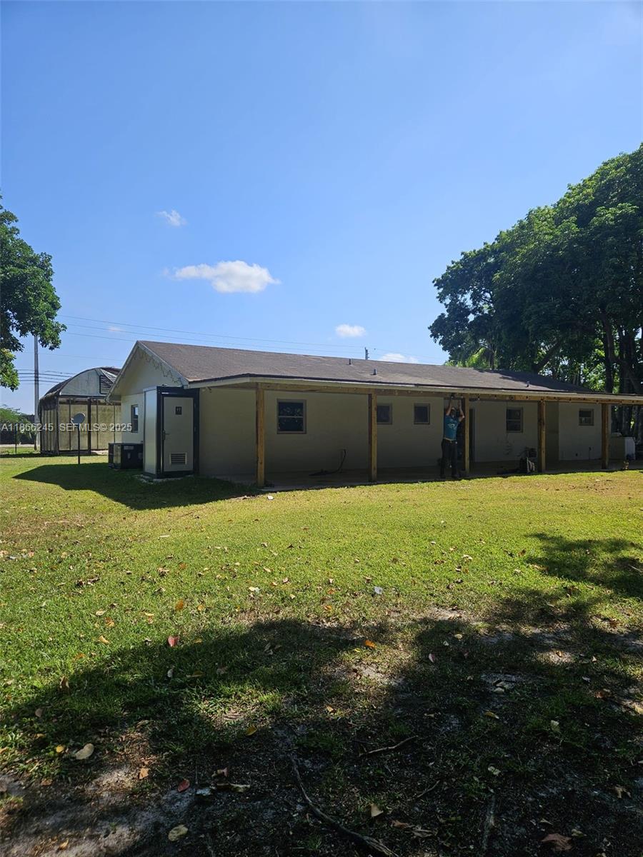 19230 Southwest 216th Street Miami, FL 33170 - Photo 18 of 55 a front view of a house with a yard
