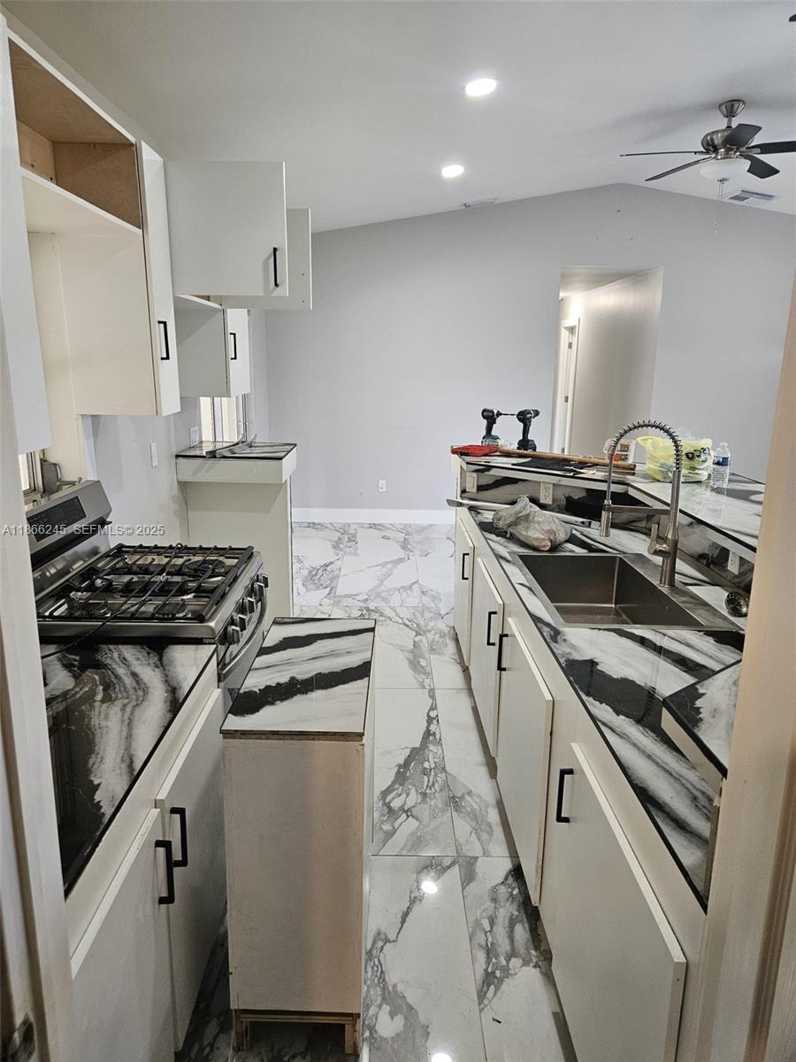 19230 Southwest 216th Street Miami, FL 33170 - Photo 20 of 55 a kitchen with granite countertop a stove and a sink