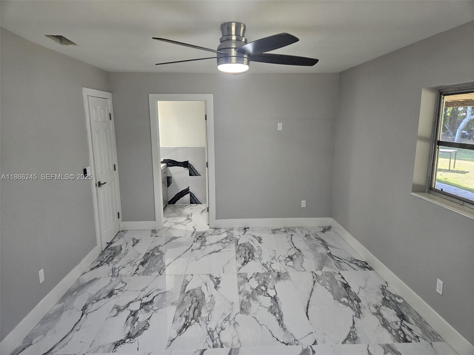 19230 Southwest 216th Street Miami, FL 33170 - Photo 21 of 55 a bedroom with a bed and a window