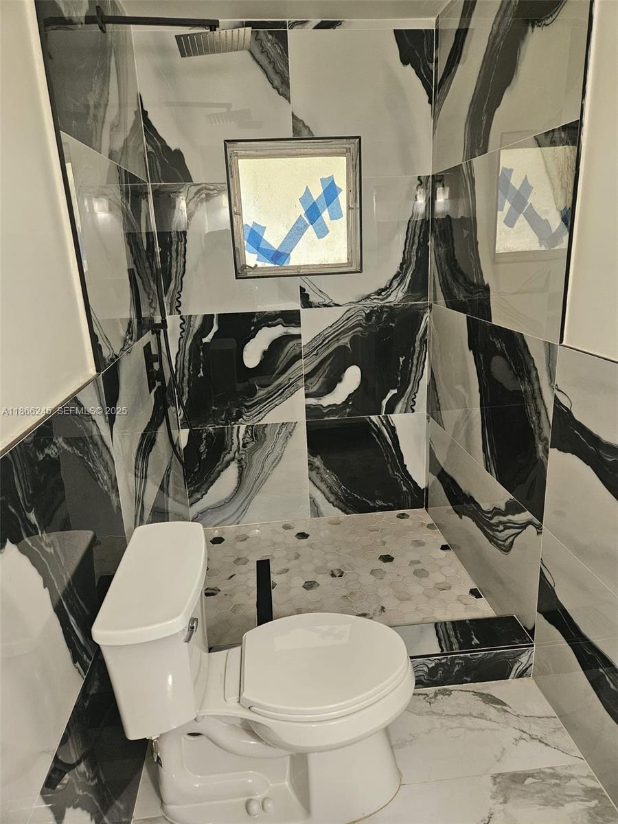 19230 Southwest 216th Street Miami, FL 33170 - Photo 22 of 55 a bathroom with a toilet and a sink