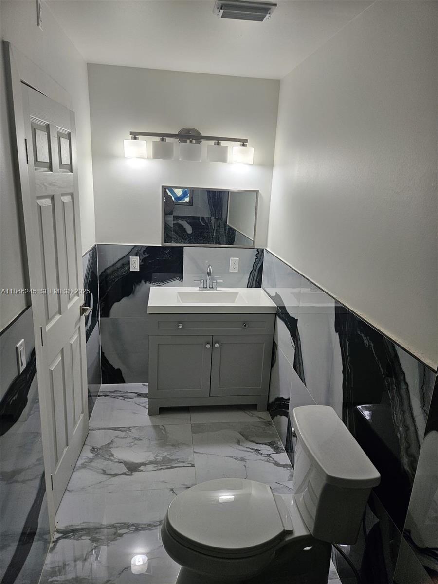 19230 Southwest 216th Street Miami, FL 33170 - Photo 25 of 55 a bathroom with a sink toilet and a mirror