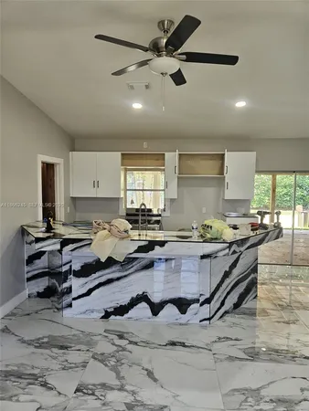 a living room with furniture and kitchen view