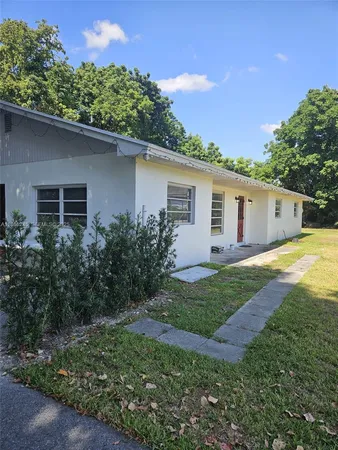 a kitchen with a stove a refrigerator and hallway