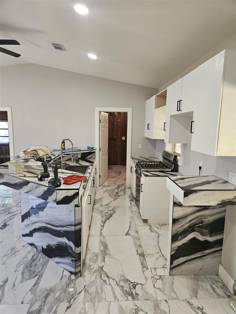19230 Southwest 216th Street Miami, FL 33170 - Photo 36 of 55 a kitchen with a stove a refrigerator and hallway
