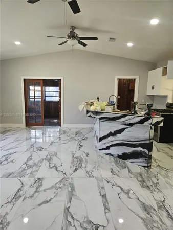 a view of a kitchen with a sink and cabinets