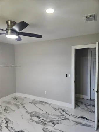 a work room with furniture and chandelier