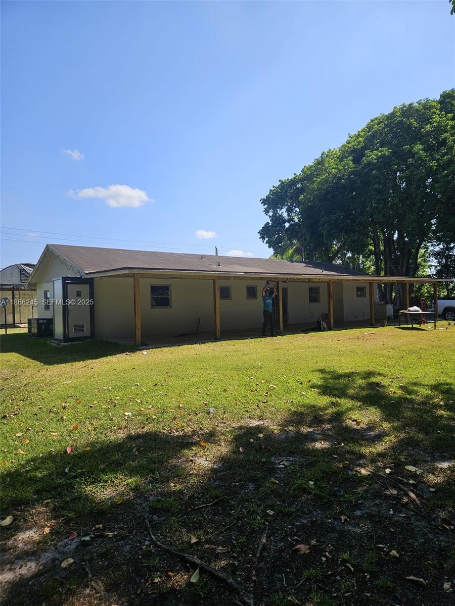 19230 Southwest 216th Street Miami, FL 33170 - Photo 4 of 55 a front view of a house with a yard