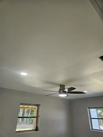a view of a house with a yard and potted plants