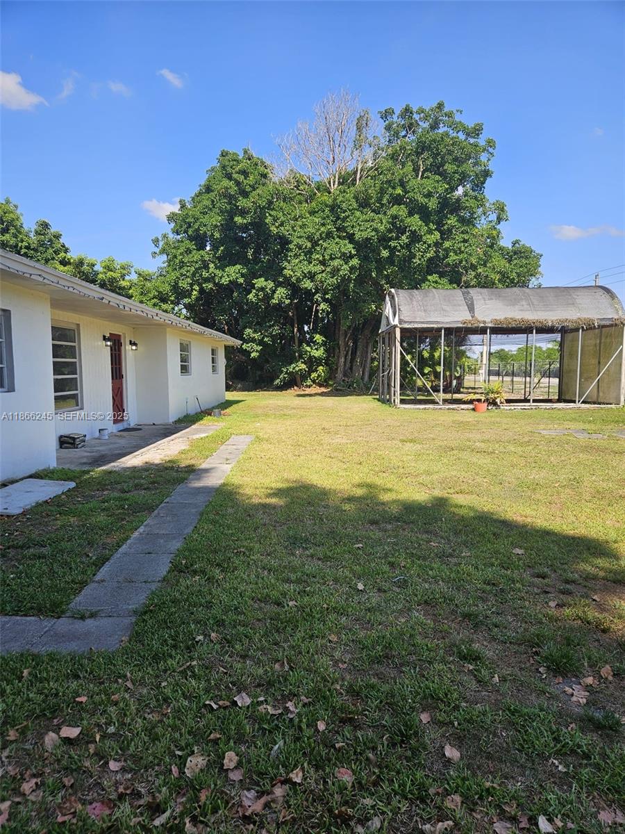 19230 Southwest 216th Street Miami, FL 33170 - Photo 46 of 55 a view of a house with a yard and potted plants