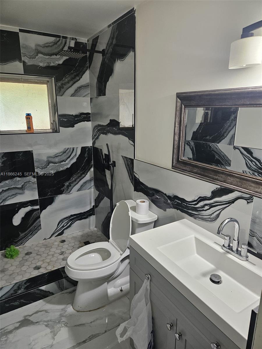 19230 Southwest 216th Street Miami, FL 33170 - Photo 52 of 55 a bathroom with a sink and a toilet