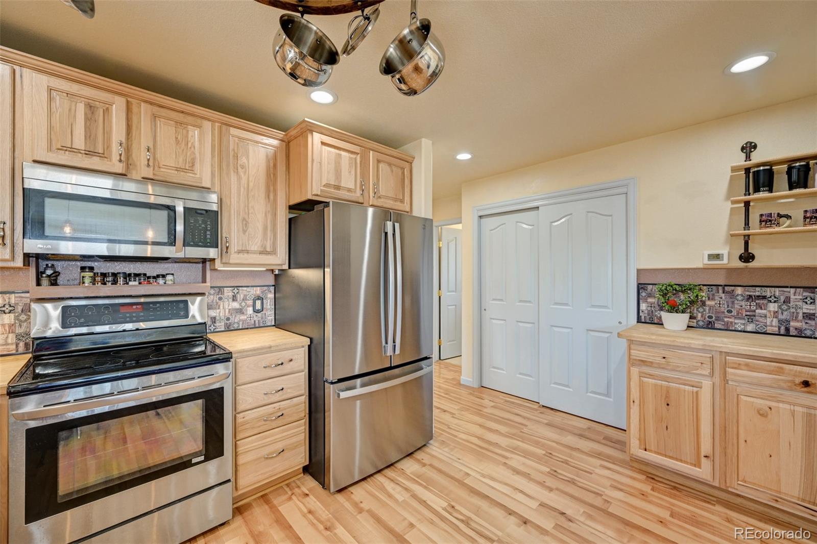 9473 Ranch Road Hartsel, CO 80449 - Photo 12 of 50 a kitchen with stainless steel appliances a stove microwave and a refrigerator
