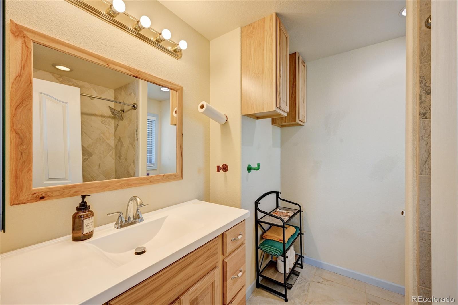 9473 Ranch Road Hartsel, CO 80449 - Photo 16 of 50 a bathroom with a sink vanity and a mirror