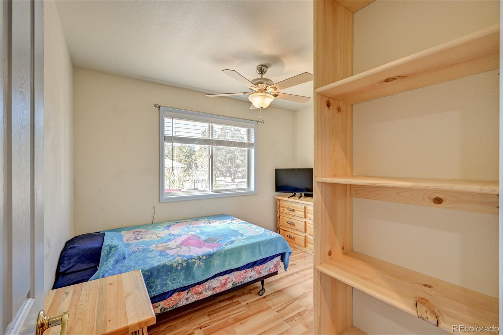 9473 Ranch Road Hartsel, CO 80449 - Photo 21 of 50 a bedroom with a bed and a window with a livingroom