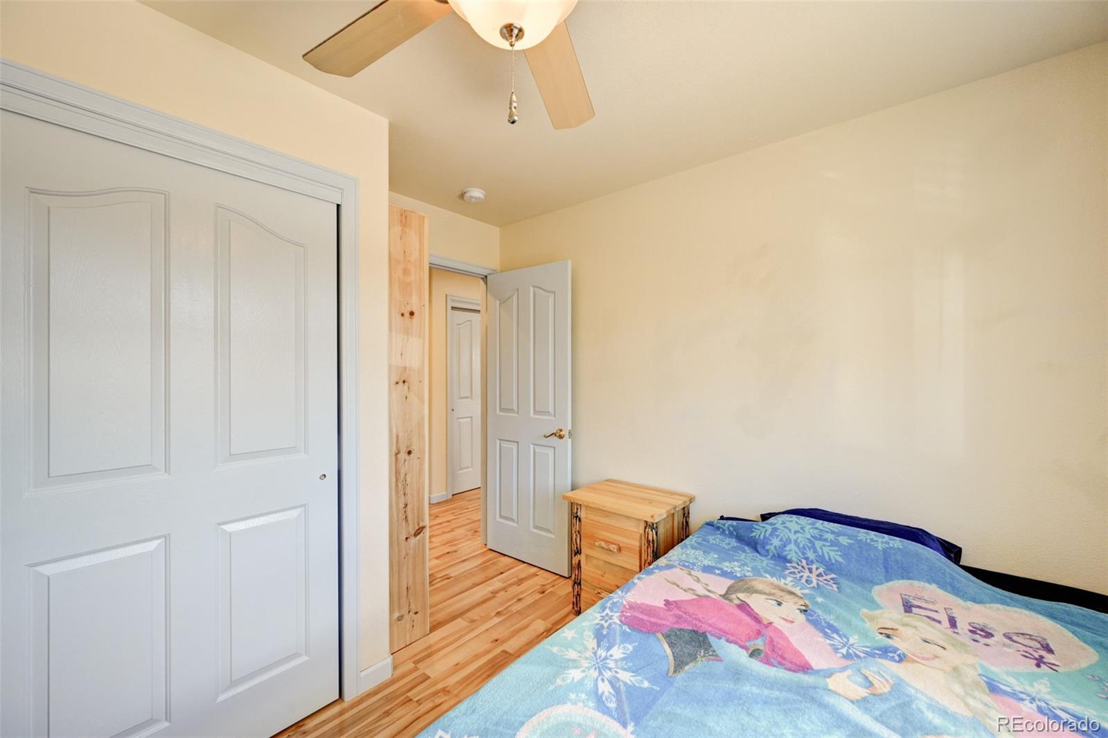 9473 Ranch Road Hartsel, CO 80449 - Photo 23 of 50 a bedroom with bed and wooden floor