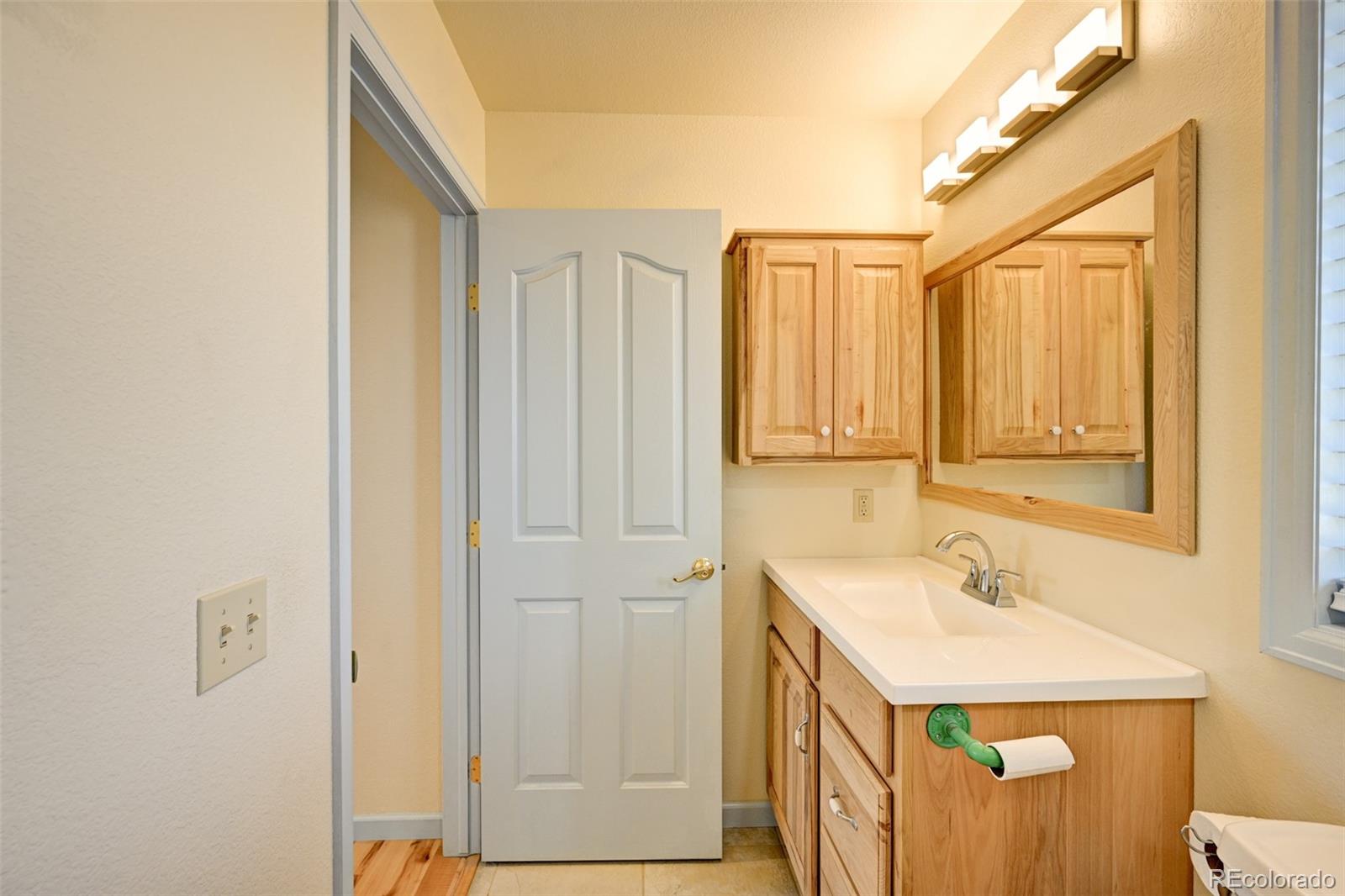 9473 Ranch Road Hartsel, CO 80449 - Photo 26 of 50 a bathroom with a sink a mirror and a shower