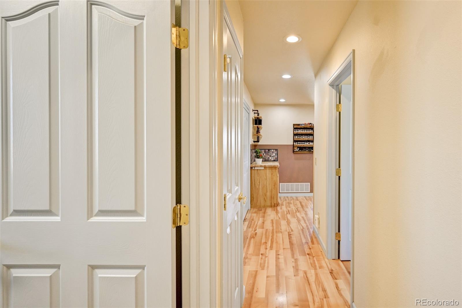 9473 Ranch Road Hartsel, CO 80449 - Photo 28 of 50 a view of a hallway with wooden floor and a bathroom