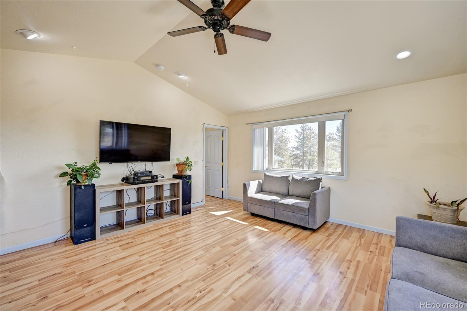 9473 Ranch Road Hartsel, CO 80449 - Photo 3 of 50 a living room with furniture and a flat screen tv