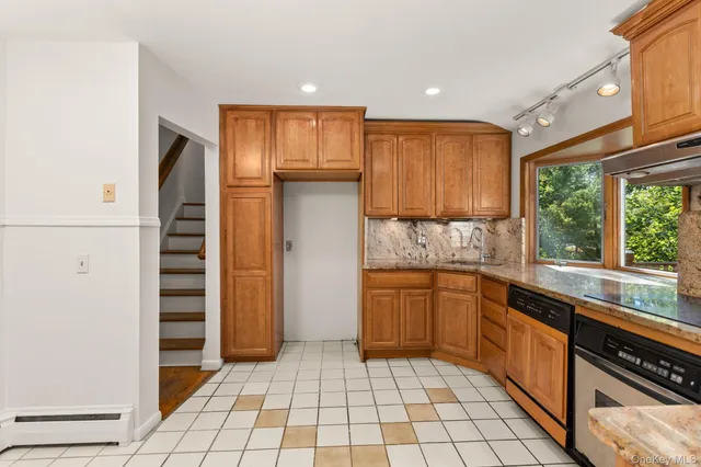 a kitchen with stainless steel appliances granite countertop a refrigerator and a sink