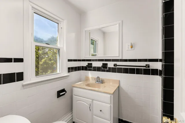 a bathroom with a sink a toilet and a mirror