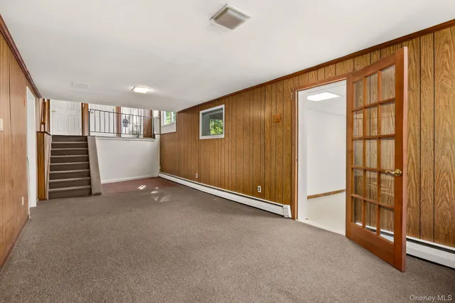 a view of an empty room with a fireplace and a window