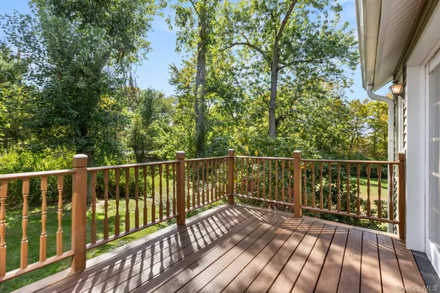 a view of balcony with wooden floor and fence