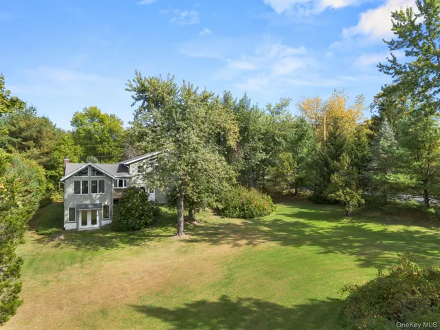 a view of a house with a yard and sitting area