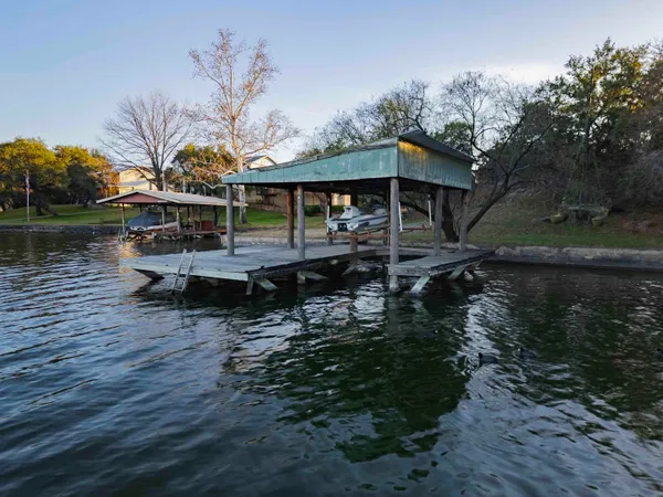 a view of a house with pool and lake view